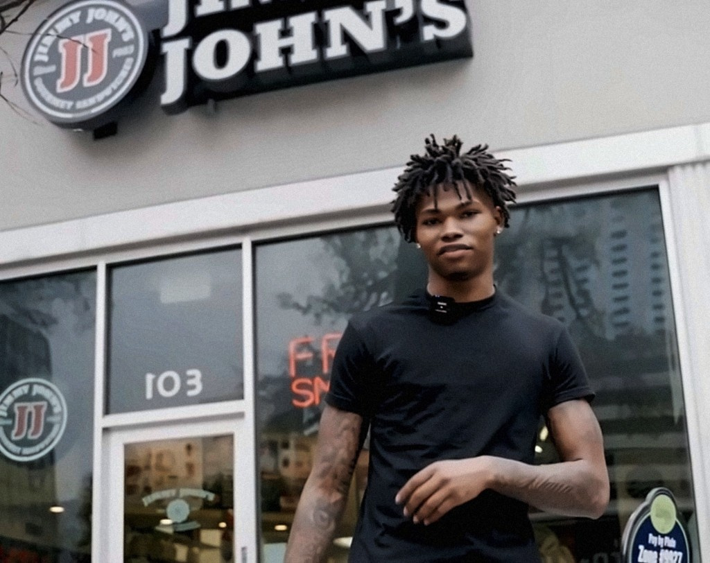 Creator outside a Jimmy John's storefront
