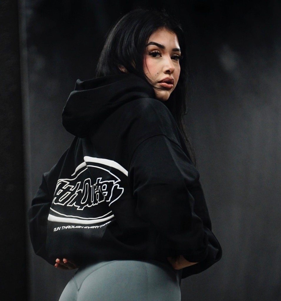 Creator in a black Run Through Everything hoodie