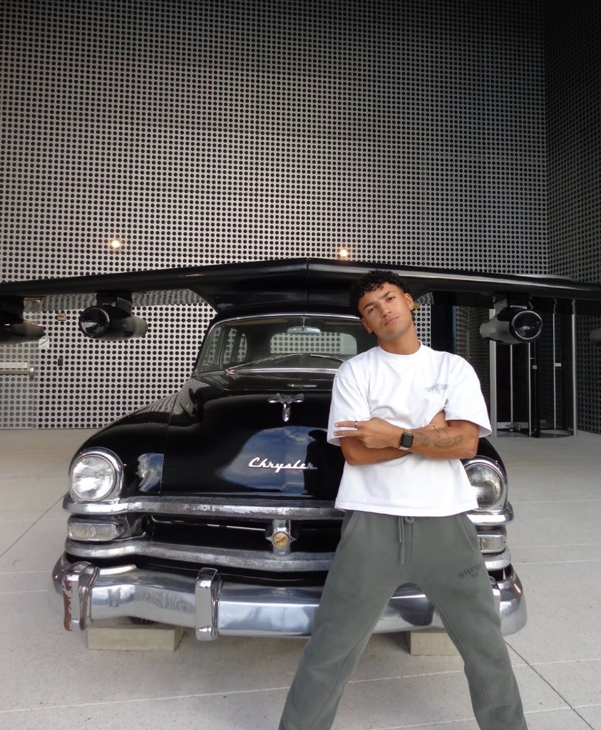Creator posing with a classic Chrysler